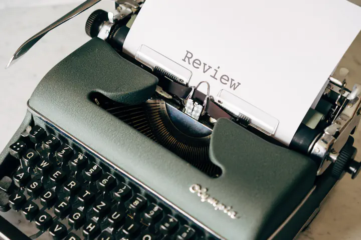 Typewriter showing the text REVIEW.